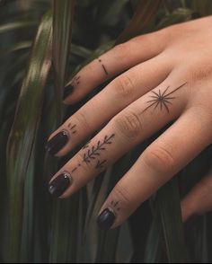 a woman's hand with tattoos on it