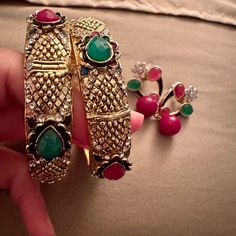 Elevate Your Style With This Stunning Set Of Two Bangles And Matching Earrings, Adorned With Large Green, Pink, And White Stones. The Vibrant Blend Of Colors Adds A Touch Of Glamour To Your Ensemble, Making It A Perfect Choice For Both Festive Occasions And Everyday Elegance. These Meticulously Crafted Accessories Reflect A Harmonious Balance Of Tradition And Contemporary Style, Making A Bold Statement Wherever You Go. Embrace The Brilliance Of These Bangles And Earrings, Celebrating The Vivid B Multicolor Jewelry With Matching Earrings, Multicolor Jewelry Sets With Matching Earrings For Parties, Multicolor Jewelry Set With Matching Earrings For Party, Trendy Gold Jewelry For Festive Occasions, Trendy Gold Festive Jewelry, Multicolor Jeweled Metal Earrings, Multicolor Metal Jewelry Sets For Party, Multicolor Jeweled Earrings For Wedding, Multicolor Jeweled Drop Earrings