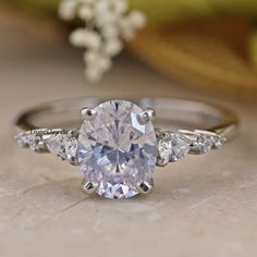 an oval cut engagement ring with three side stones