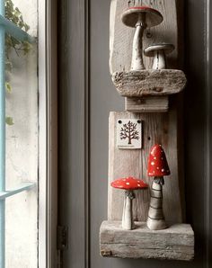 two mushrooms are sitting on top of a wooden shelf in front of a door,