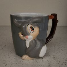 a ceramic coffee mug with an image of a rabbit on it