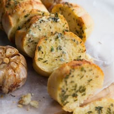 garlic bread is sitting on top of parchment paper