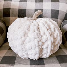 a white pumpkin sitting on top of a couch