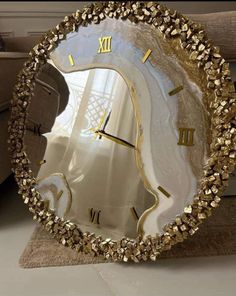 a clock made out of gold and white stones