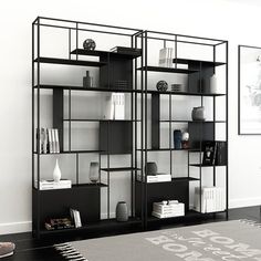 a black and white bookcase with books on it's shelves in a living room