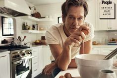 a man sitting at a kitchen counter in front of a bowl with eggs on it