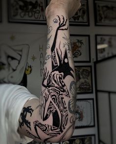 a man's arm with tattoos on it