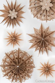 four different types of paper stars on a white surface