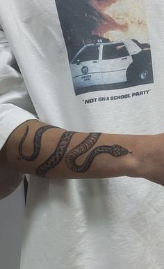 a man with a snake tattoo on his arm