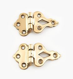 pair of brass plated cabinet door hinges