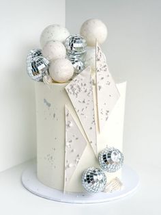 a white cake with silver decorations on top