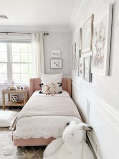 a bedroom with a bed and pictures on the wall