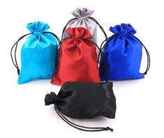 three drawsewl bags in different colors on a white background with one black, one red and one blue