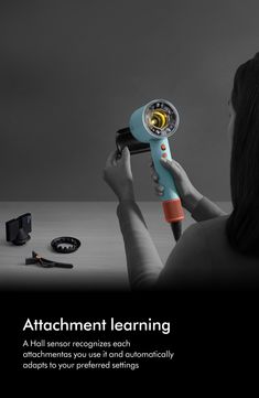 a woman holding a hair dryer in front of her face with the caption attachment learning