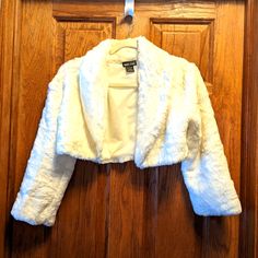 Like Brand New- Size S, Fully Lined, Color Is White, 15" L, 18.5" Sleeves, 3.5" Inseam. A Bolero Jacket Is A Short, Open-Front Jacket. Some Bolero Jackets Cinch Or Tie At A Central Point Above The Sternum. Bolero Jackets Are A Fixture Of Formal Women’s Clothing And Eveningwear, And This Stylish Cropped Jacket Works As A Fashionable Cover-Up For People Of All Genders. Fitted Long Sleeve Blazer In Winter White, Fitted Winter White Long Sleeve Blazer, Fitted Winter White Blazer, Winter White Fitted Blazer, Fitted White Blazer For Winter, White Fitted Cropped Jacket For Winter, White Long Sleeve Cropped Jacket For Winter, Fitted Cream Blazer For Winter, Formal Women