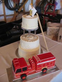 wedding cakes and figurines are on display at the reception table, along with an image of a bride and groom