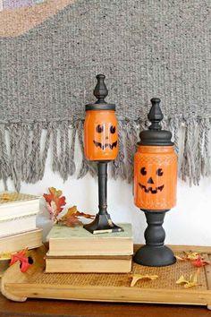 two pumpkin jars sitting on top of a wooden table