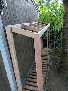 a wooden structure sitting next to a tree