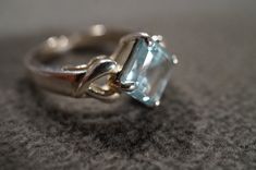 I am offering you this vintage sterling silver Art Deco style band ring with a gorgeous prong set trillion triangle shaped, genuine blue topaz stone. There is a regal influence in the design here, very nice! There is fabulous design setting. It measures app. 3/4 inch, by app. 1/4 inch. It has color saturation and intensity that is endless, as seen in the provided pictures. What an eye catcher! It has the classic highly desired solid setting that is very thick and substantial, giving this ring al Formal Trillion Cut Topaz Ring In Fine Jewelry Style, Formal Trillion Cut Topaz Fine Jewelry Ring, Silver Heart Cut Topaz Ring, Elegant Trillion Cut Topaz Promise Ring, Elegant Trillion Cut Topaz Ring, Silver Trillion-cut Solitaire Jewelry, Silver Trillion Cut Solitaire Jewelry, Blue Topaz Heart Cut Jewelry For Formal Occasions, Trillion Cut Topaz Jewelry For Anniversary