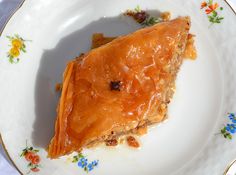 a piece of pie sitting on top of a white plate with blue and yellow flowers