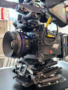 a camera sitting on top of a table with a lens attached to it's body