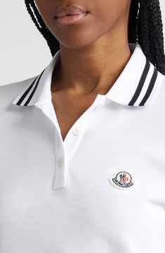 Cut in a slim fit from cotton piqué, this polo checks all the boxes of classic styling with its tipped collar and cuffs and the distinctive Moncler logo patch. Button half-placket Spread collar Short sleeves Side slits Drop-tail hem 100% cotton Dry clean or machine wash, dry flat Made in Turkey Designer Clothing Classic Polo Shirt With Contrast Stripes, Luxury Polo Shirt With Striped Collar, Classic Top With Polo Collar And Striped Cuffs, Classic Tops With Polo Collar And Striped Cuffs, Classic Tops With Striped Cuffs And Polo Collar, Elegant White Polo Shirt With Ribbed Collar, Designer White Tops With Ribbed Collar, Classic White Polo Shirt With Contrast Collar, Luxury Polo Shirt With Ribbed Collar For Work