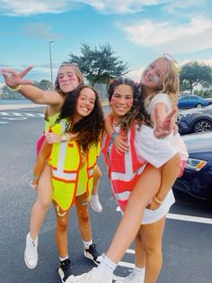 three girls in safety vests are posing for the camera