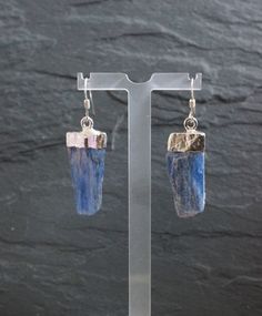 Raw Blue Kyanite earrings edged in Silver or Gold on a Sterling Silver or Gold Filled earring hook.  Matching necklace can be seen here http://etsy.me/1HocNQ2 Your one-of-a kind earrings will arrive in a Goddess gift box.  Blue Kyanite is especially good for working with the Throat Chakra and communication issues. Blue Kyanite helps to speak one's truth with clarity, making it a great stone for public speakers and performers. It immediately aligns the chakras and subtle bodies, bringing tranquility and a calming effect to the whole being. It is an exceptional stone for transitioning into deep meditative states Stone: Kyanite Size: 1/2-1" inch Color: blue, white, silver Earring: Gold Filled or Sterling Silver ✭ packaging ✭ Your necklace will arrive in a complimentary gift box, ready for gif Gift Box Blue, Communication Issues, Kyanite Earrings, Kyanite Jewelry, The Throat Chakra, Citrine Earrings, Les Chakras, Blue Kyanite, The Chakras