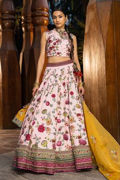 Blush pink lehenga with all-over floral printed motifs, embroidered border and cutwork hem. Paired with printed blouse. Comes with a yellow embroidered dupatta.
Component: 3
Pattern: Printed, Embroidered
Type Of Work: Floral motifs
Neckline: Round neck
Sleeve Type: Sleeveless
Fabric: Blouse and lehenga skirt: Natural silk, Dupatta: Soft net
Color: Pink
Other Details: 
Back zipper
Printed motifs
Cutwork hem lehenga
Note: The necklace, bag shown, blue lehenga set and outfit worn by the other male Mehandi Outfits, Sangeet Outfit, Blue Lehenga, Pink Lehenga, Lehenga Skirt, Natural Silk, Bridal Set, Blouse Length, Floral Motifs