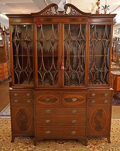 an old wooden china cabinet with glass doors