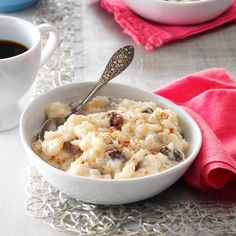 a bowl of oatmeal next to two cups of coffee