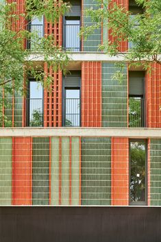 an orange and green building with many windows