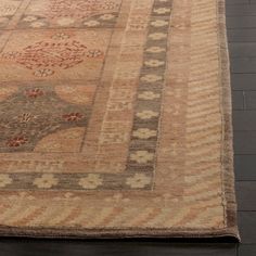 a large rug with an intricate design on the top and bottom, sitting on a wooden floor