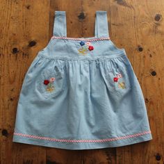 FRENCH VINTAGE 50's, beautiful littlepinafore dress / apron dress, light blue cotton fabric, floral embroideries and pink ric-rac detailing, two cute side pockets, buttoned in the back down to the waist ( glass buttons ). Length 17,9" Estimated size 2 years New old stock ( washed once ) In case of multiple purchases, if you want an accurate shipping estimation, please contact me ; I do always refund overcharged shipping from 1 Euro overpaid ! Thank you for your visit Cute Blue Dresses With Floral Applique, Cute Blue Dress With Floral Applique, Light Blue Cotton Sundress For Spring, Blue Cotton Dress With Floral Applique, Light Blue Cotton Sundress, Spring Cotton Pinafore Dress For Garden Party, Embroidered Light Blue Cotton Dress, Spring Garden Party Cotton Pinafore Dress, Light Blue Embroidered Cotton Dress