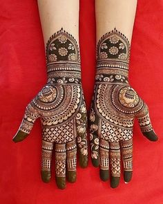 two hands with henna designs on them