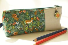 Pencil case /Pencil bag/ Pencil pouch / makeup bag / cosmetic bag/ zipper pull/sewing bag/tropical This is a lovely zipper pencil case for your children or yourself.  It could also be used to carry your cosmetics or sewing kit. These pencil cases are a hit at my children's school! Size: Length 22 cm; height 10 cm; width at base 5.5 cm 20 cm zipper. Materials: Exterior: a combination of beige linen and a lovely cotton fabric featuring a tropical forrest with birds, flowers; tigers and leopards on Green Pencil Case Pouch For Daily Use, Green Pouch Pencil Case For Daily Use, Green Zipper Pouch Pencil Case For School, Green Pencil Case Pouch With Pen Holders, Green Zipper Pencil Case For School, Daily Use Pencil Case With Zipper, Green Pencil Shaped Case With Zipper Closure, Green Zipper Pouch Pencil Case, Green Rectangular Pencil Case With Zipper