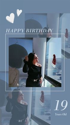 a woman in black dress standing next to a window with the words happy birthday on it