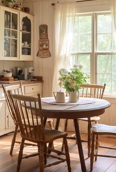 Whimsy meets warmth in these cottagecore dining rooms. If you’re... Round Kitchen Table With Tablecloth, Vintage Farmhouse Kitchen Table, Cottage Kitchen Table And Chairs, Vintage Kitchen Table And Chairs, Kitchen Table In Small Kitchen, Cottage Core Kitchen Table, Small Kitchen With Table, Old Farmhouse Dining Room, Wooden Chairs For Dining Table