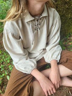 a woman sitting on the ground with her eyes closed