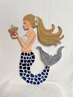 a painting of a mermaid holding a starfish