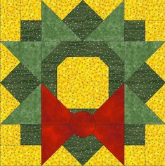 a yellow and green quilt with a red bow on the center is featured in this image