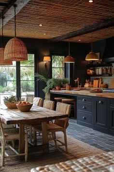 a dining room table surrounded by chairs in front of an open kitchen with lots of windows