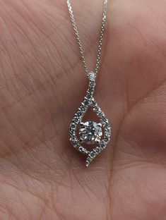 "This is a beautiful Lab Grown diamond design pendant.  It is set in real solid 14Kt Gold and the chain is 14Kt Gold as well.  You can choose if you want 14Kt White Gold, 14Kt Yellow Gold or 14Kt Rose Gold.  We have a lot of beautiful jewelry with natural diamonds. If any listing states \"diamond\" then it is a natural diamond. If the listing states \"Lab Grown\" it is a Lab Grown diamond. It has a special loop where the chain goes through so that the diamond sits comfortably on you when you wear it. This is the perfect gift for mom, wife, fiancee, girlfriend, valentine, daughter, family or friend. It is a special gift for mother's day, valentine's day, wedding, anniversary, birthday, Christmas, Easter, New Year's and any holiday. Center Diamond: 0.65 Carat Halo Diamonds: 0.35 Carats Color Dazzling Diamond Cut Necklace For Anniversary, Diamond Cut Solitaire Pendant Necklace For Anniversary, Wedding 14k White Gold Diamond Cut Necklace, Gia Certified Diamond Necklace In Fine Jewelry Style, Dazzling 14k White Gold Diamond Necklace For Wedding, Gia Certified Round Cut Diamond Necklace For Anniversary, Exquisite Diamond Cut Solitaire Necklace For Anniversary, Gia Certified Silver Diamond Necklace For Wedding, Silver Gia Certified Diamond Necklace For Wedding