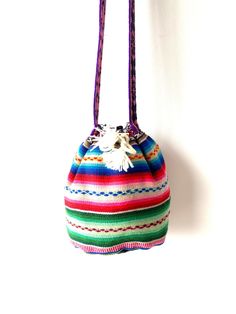 Measurements:  Height: 8 inches (20 centimeters) Base diameter: 5.5 inches  (14 centimeters) Strap length : 44 inches (112 centimeters) Black lining inside. Multicolor Rectangular Potli Bag For Daily Use, Daily Use Multicolor Rectangular Potli Bag, Handwoven Multicolor Bucket Bag For Festival, Multicolor Woven Bucket Bag As Gift, Festival Multicolor Handwoven Bucket Bag, Multicolor Woven Crochet Bag As Gift, Multicolor Handwoven Bucket Bag For Festival, Bohemian Multicolor Bucket Bag Gift, Multicolor Woven Bucket Bag Gift