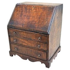 an old wooden desk with three drawers