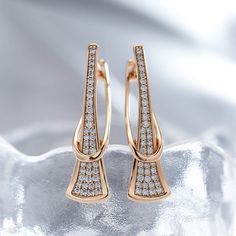 The "Isosceles" earrings features a magnificent drop design encrusted with dazzling cubic zirconia crystals throughout. Intricate curved construction and glimmering shine ensure that you are always the center of attention wherever you go. Accentuate your beauty. This is not sold in stores. and there is very limited quantity. Detailed craftsmanship Cubic zirconia encrusted Rose gold finish Gorgeous drop design For Pierced ears Material: CZ crystal. copper Cubic Zirconia Bridal Earrings With Pave Setting For Evening, Elegant Cubic Zirconia Hoop Earrings With Pave Setting, Rose Gold Diamond Crystal Earrings, Modern Cubic Zirconia Earrings With Plating, Cubic Zirconia Drop Earrings With Pave Setting, Cubic Zirconia Drop Earrings With Plating, Modern Rose Gold Cubic Zirconia Earrings, Elegant Teardrop Cubic Zirconia Hoop Earrings, Elegant Cubic Zirconia Hoop Earrings With Sparkling Stones