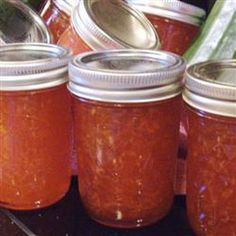 several jars filled with different kinds of food