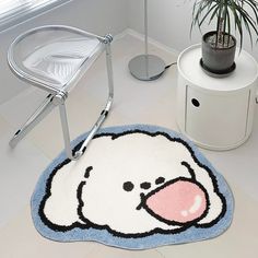 a bathroom rug with a cartoon bear on it and a potted plant in the corner