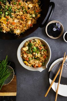 an overhead view of rice and vegetables with chopsticks