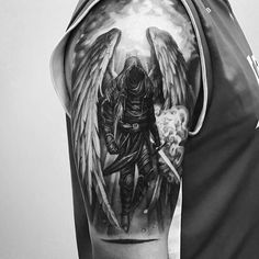 a black and white photo of a man with an angel tattoo on his arm